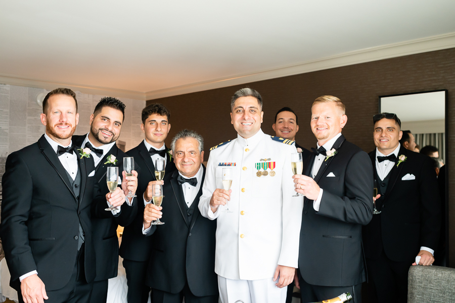 Wedding at Baltimore Harbor groomsmen preparing to toast