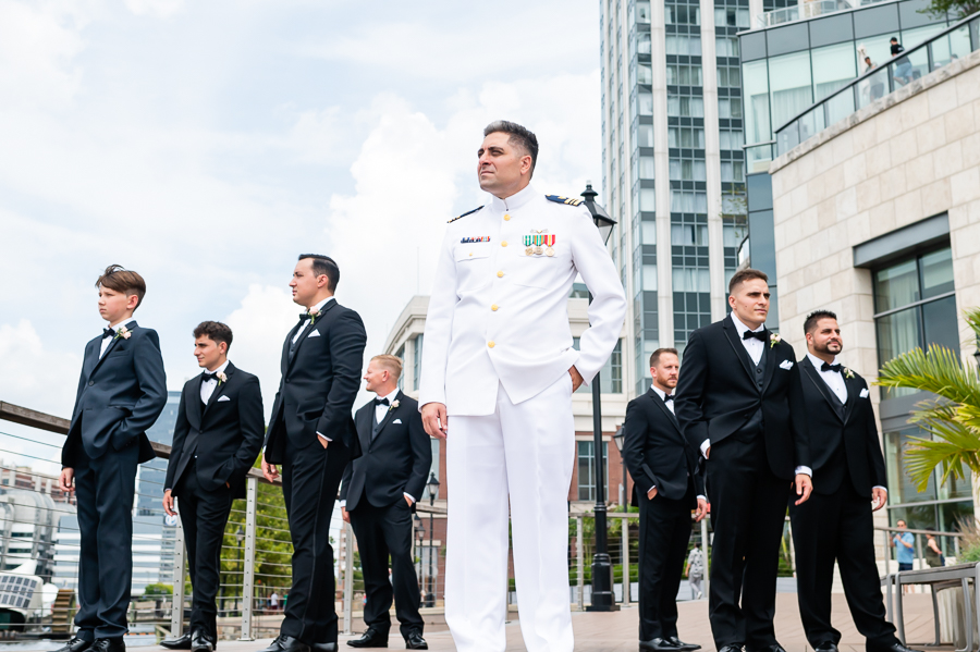 Wedding at Baltimore Harbor groomsmen in front of Baltimore Marriott Waterfront
