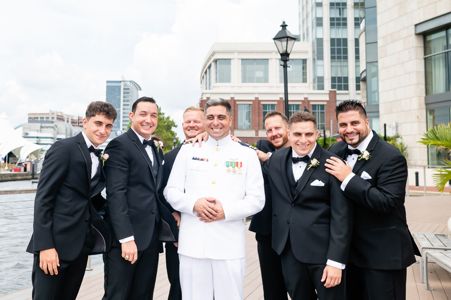 Wedding at Baltimore Harbor groomsmen in front of Baltimore Marriott Waterfront
