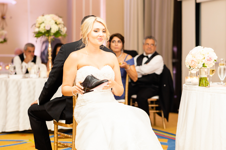 bride and groom playing the shoe game