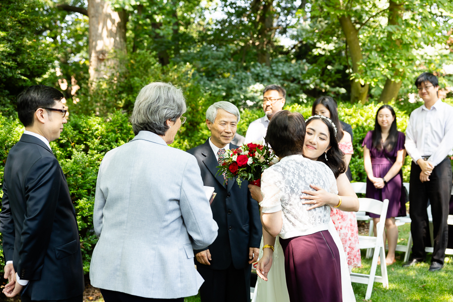 bride embracing mother after coming down the aisle 