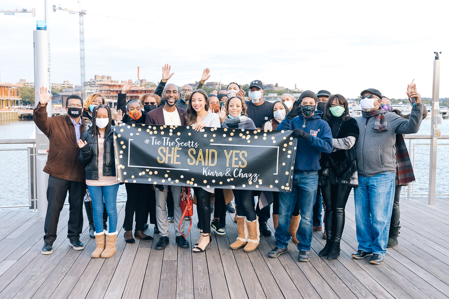 Group photo of family and friends during the Stunning DC Surprise Proposal celebration.