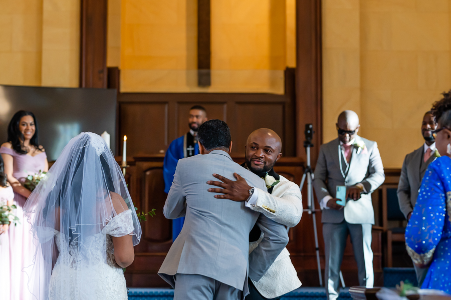 groom greeting father in law at the wedding ceremony