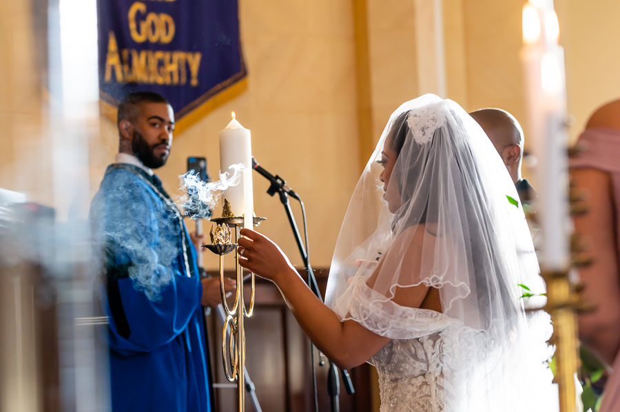 bride and groom lighting ceremony candle