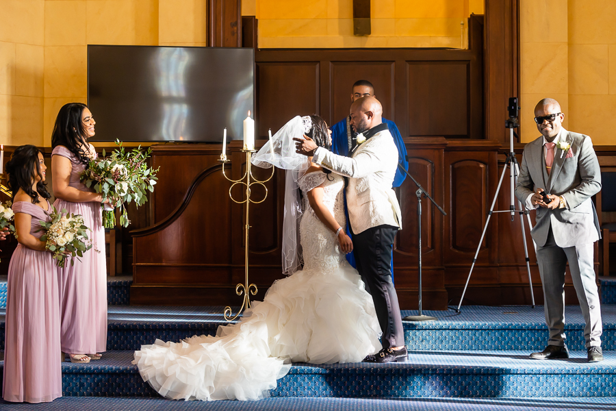 groom unveiling his bride