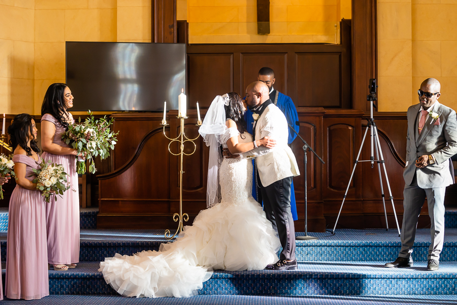 bride and groom first kiss