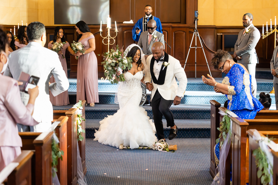 bride and groom jump the broom