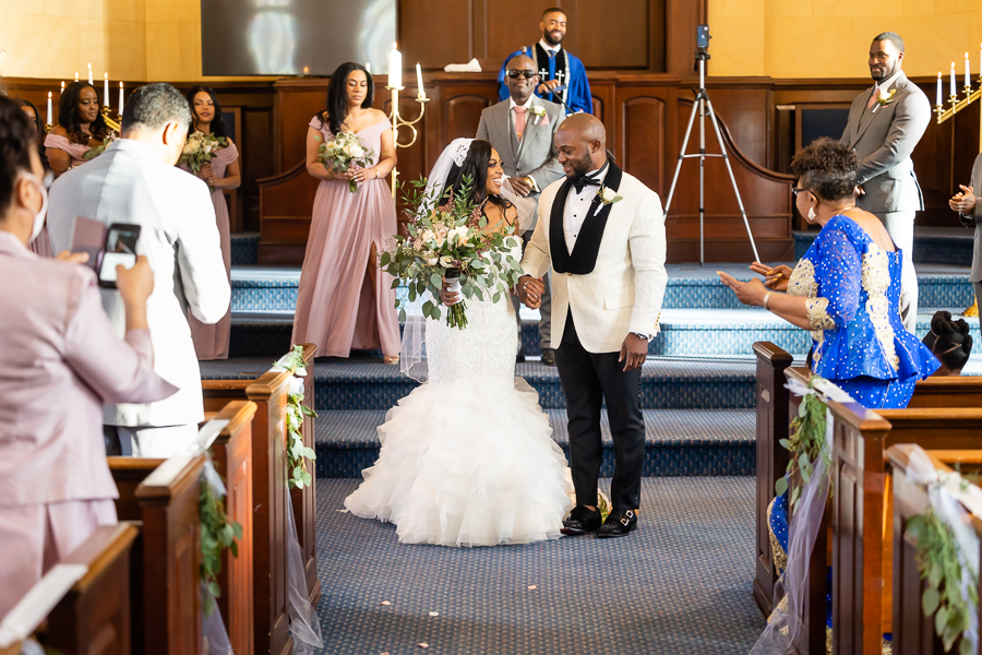 bride and groom jump the broom