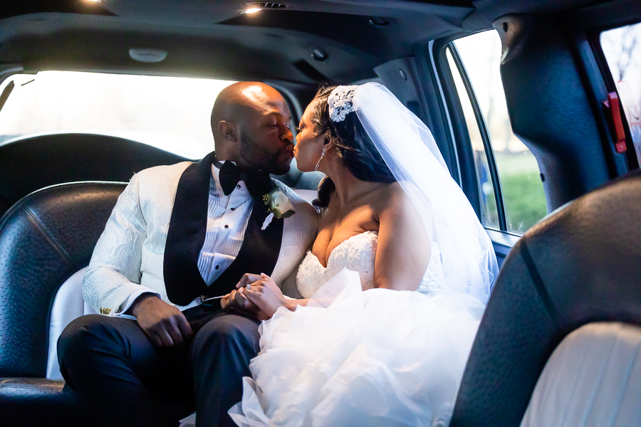 bride and groom sharing a moment in the limo