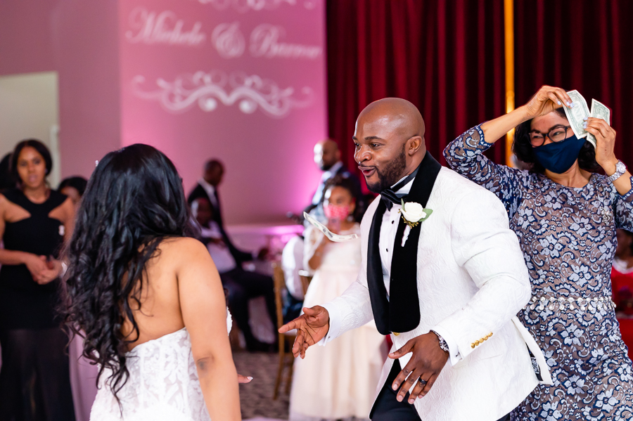 Bride and Groom getting sprayed at the Fox Chase Manor Weddings reception.