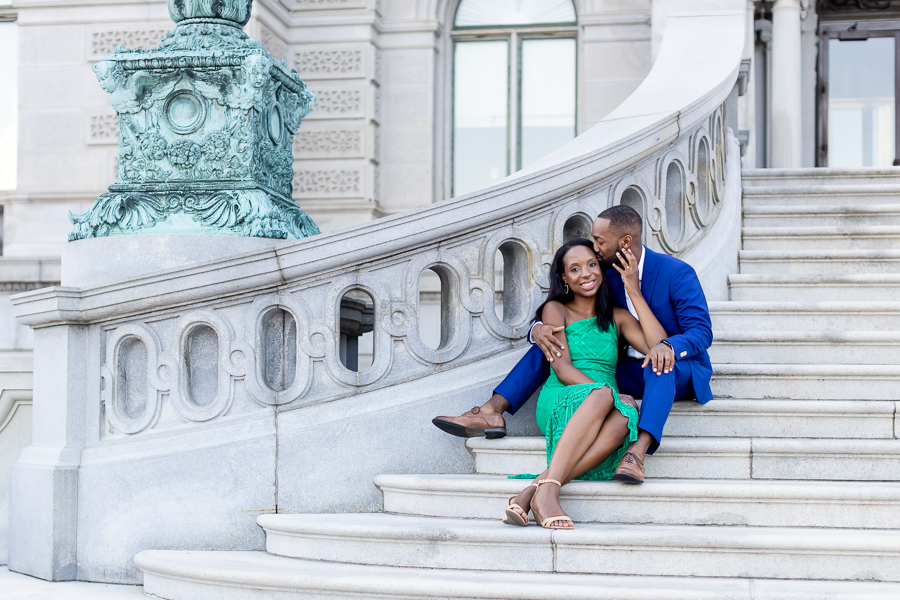 Romantic kiss with the Library of Congress dome in the background.