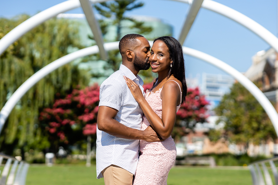 Couple sharing a smooch during their Navy Yard Waterfront engagement session.