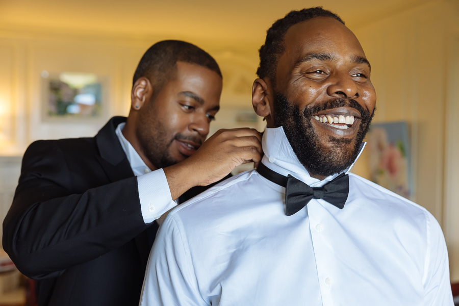 Groom adjusting bowtie before the ceremony 