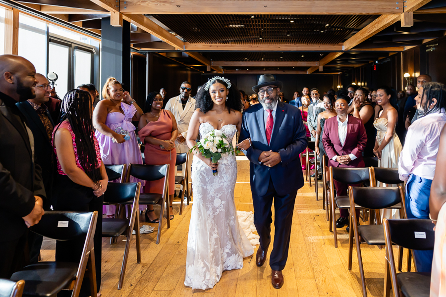 bride and father walking dow the wedding ailse