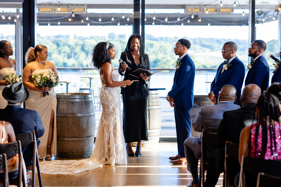 Bride and groom exchanging vows with waterfront views – District Winery wedding photography