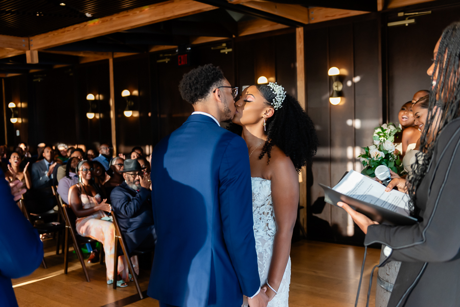 bride and groom share first kiss