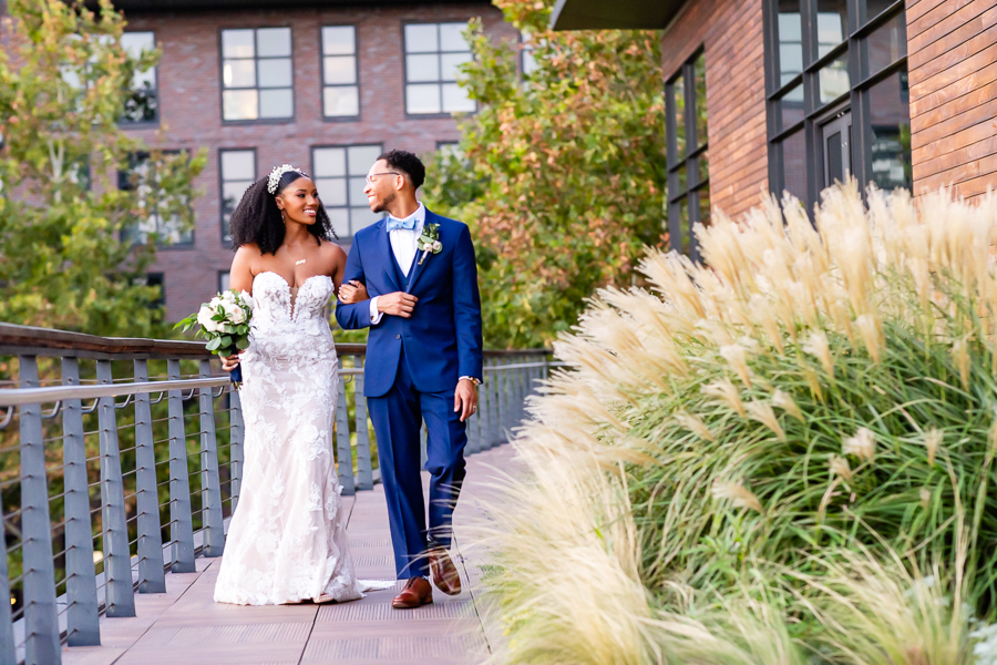 Newlyweds walking hand in hand along the waterfront – District Winery wedding photography