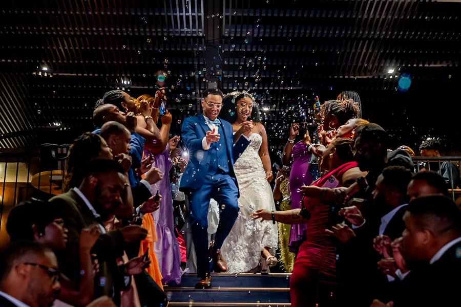 Newlyweds walking through a tunnel of bubbles – District Winery wedding photography