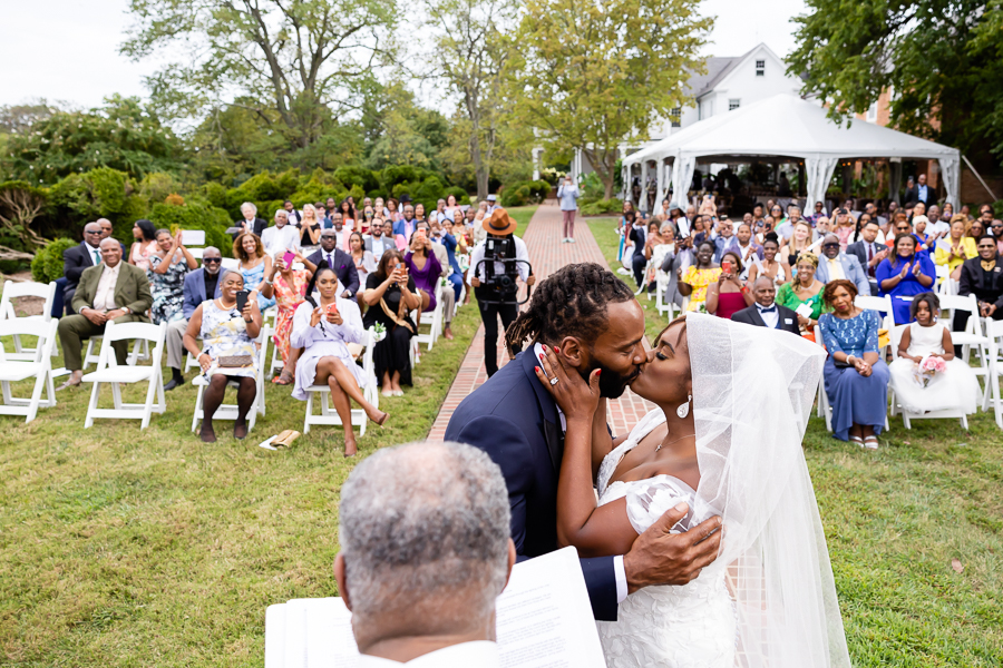 First kiss as newlyweds at River Farm Virginia wedding.