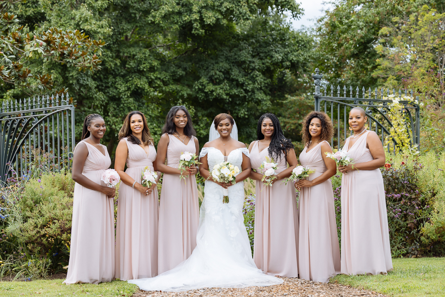 brides maids posing in gardens at River Farm Virginia wedding.