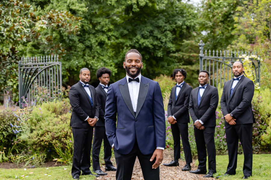 Groom and groomsmen in SUITSUPPLY tuxedos at River Farm Virginia wedding.
