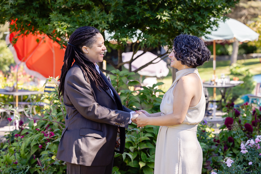 smiling together during their garden wedding at Zinnia in Silver Spring Maryland