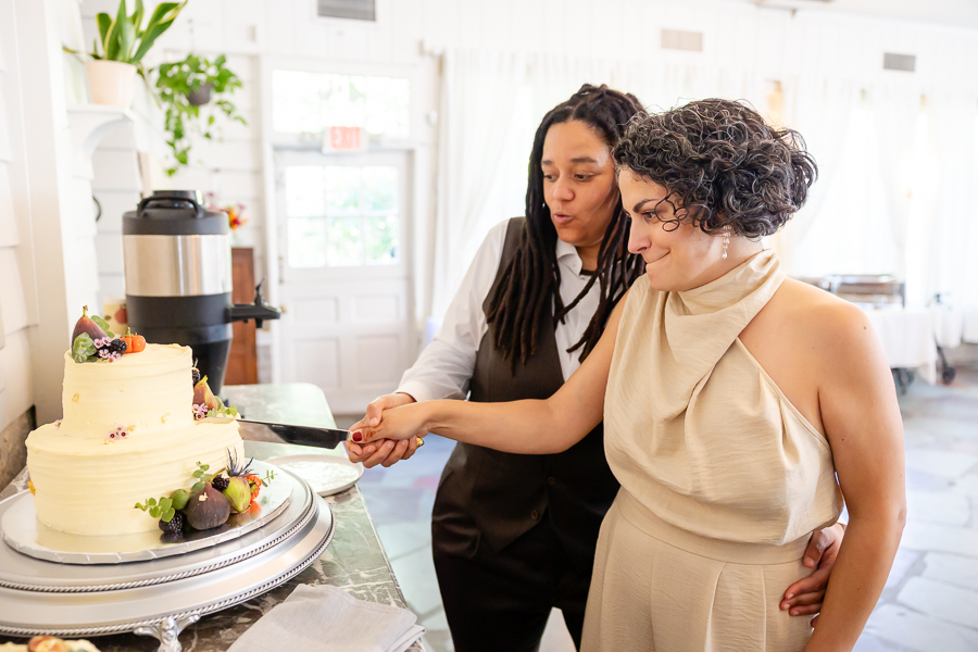 Wedding cake cutting moment at Zinnia restaurant wedding celebration