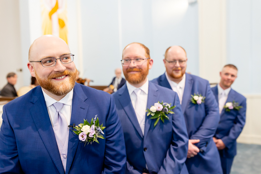 groom anticipating his bride walking down aisle 