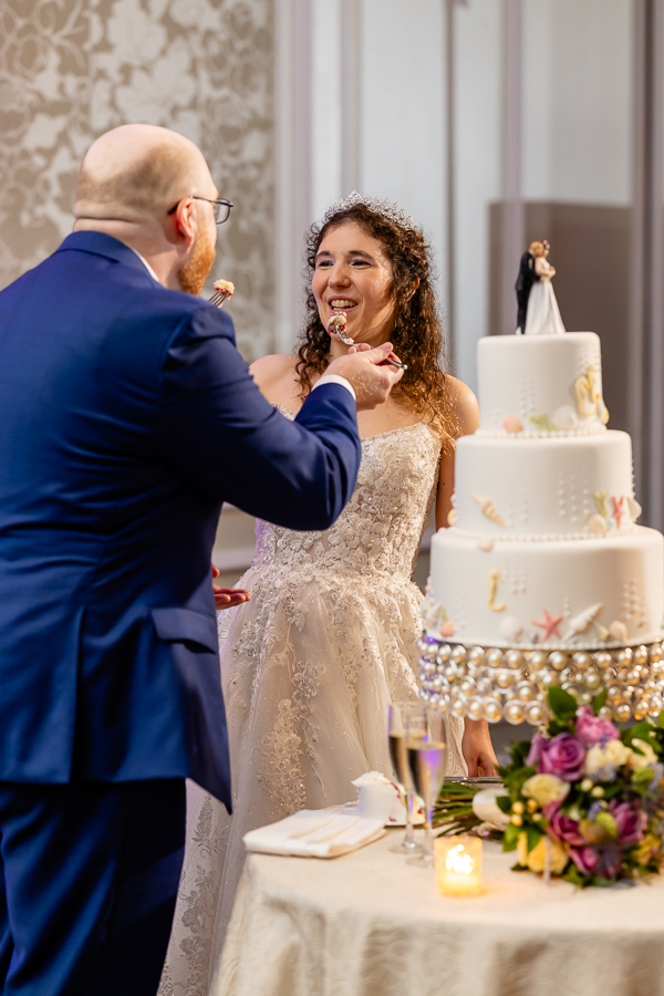 bride and groom sharing the wedding cake